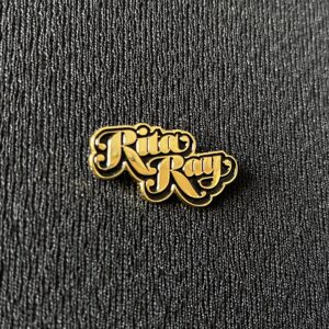 Rita Ray golden metallic pin